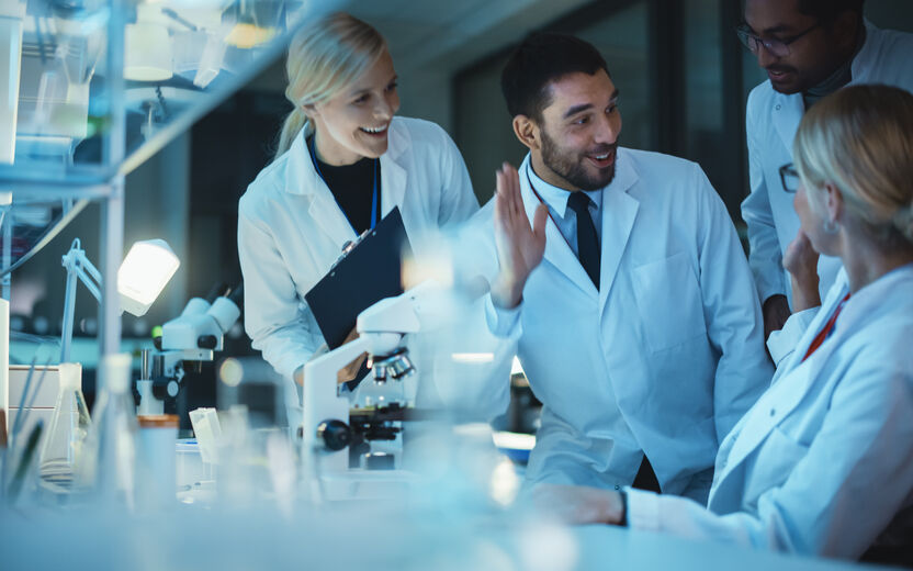 stock image of scientists high fiving to demonstrate fellows