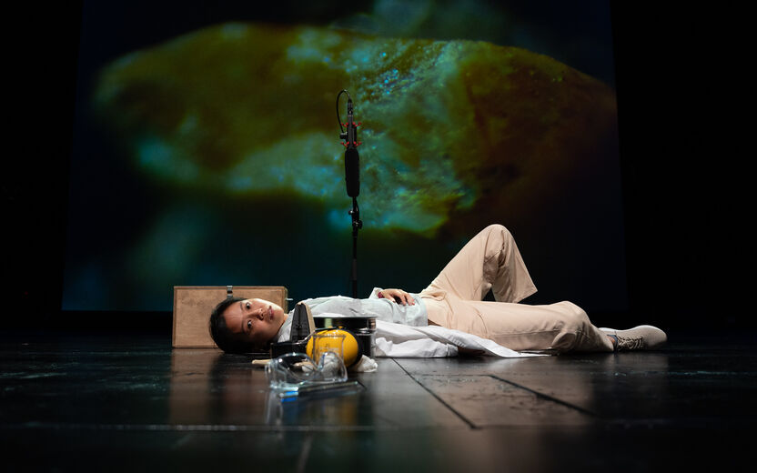 Trial & Theatre performer En Ping Yu lies on the floor of the stage