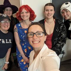 A group of smiling people in Halloween costumes